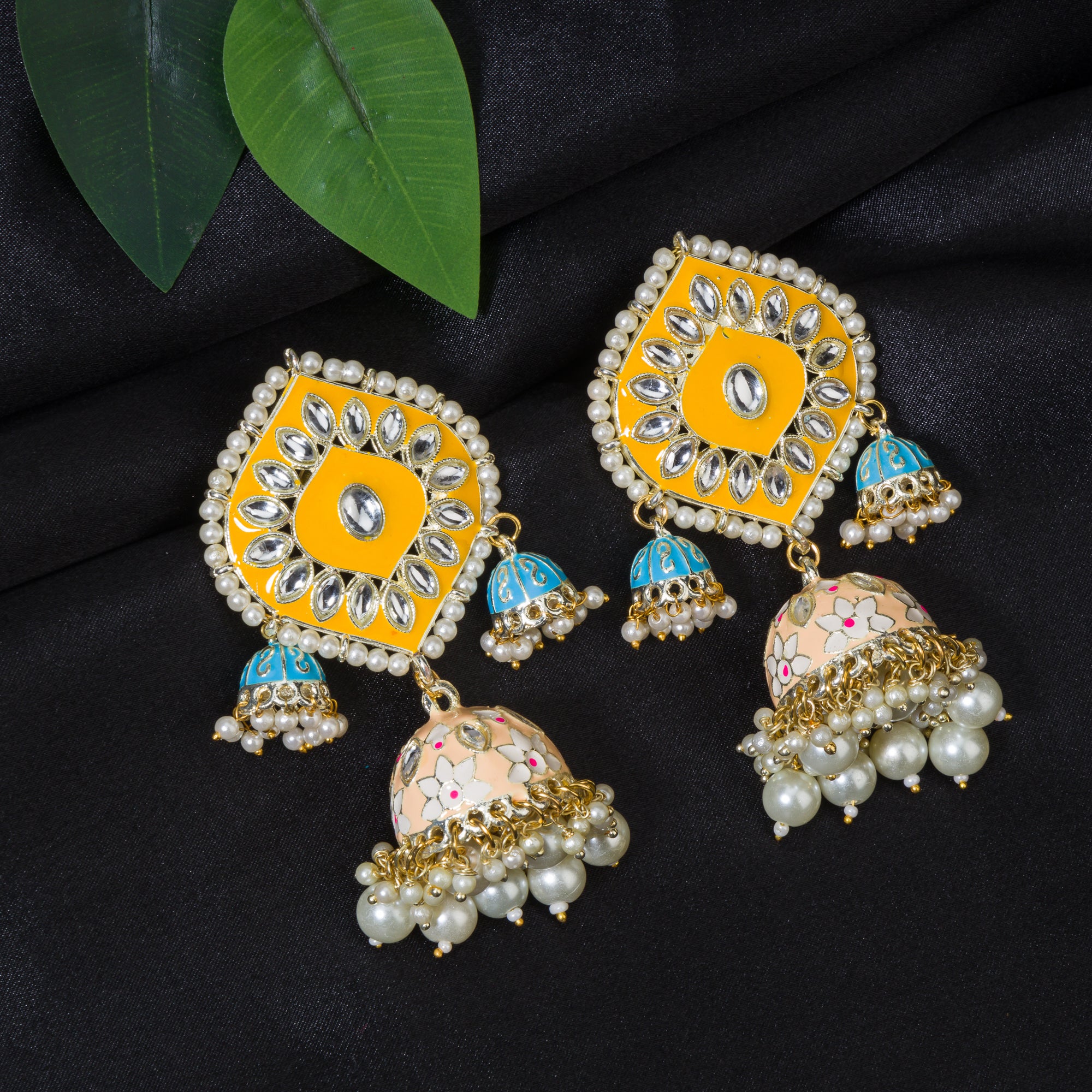 "Yellow and blue gold jhumka earrings blend bold colors with classic elegance for a striking look."
