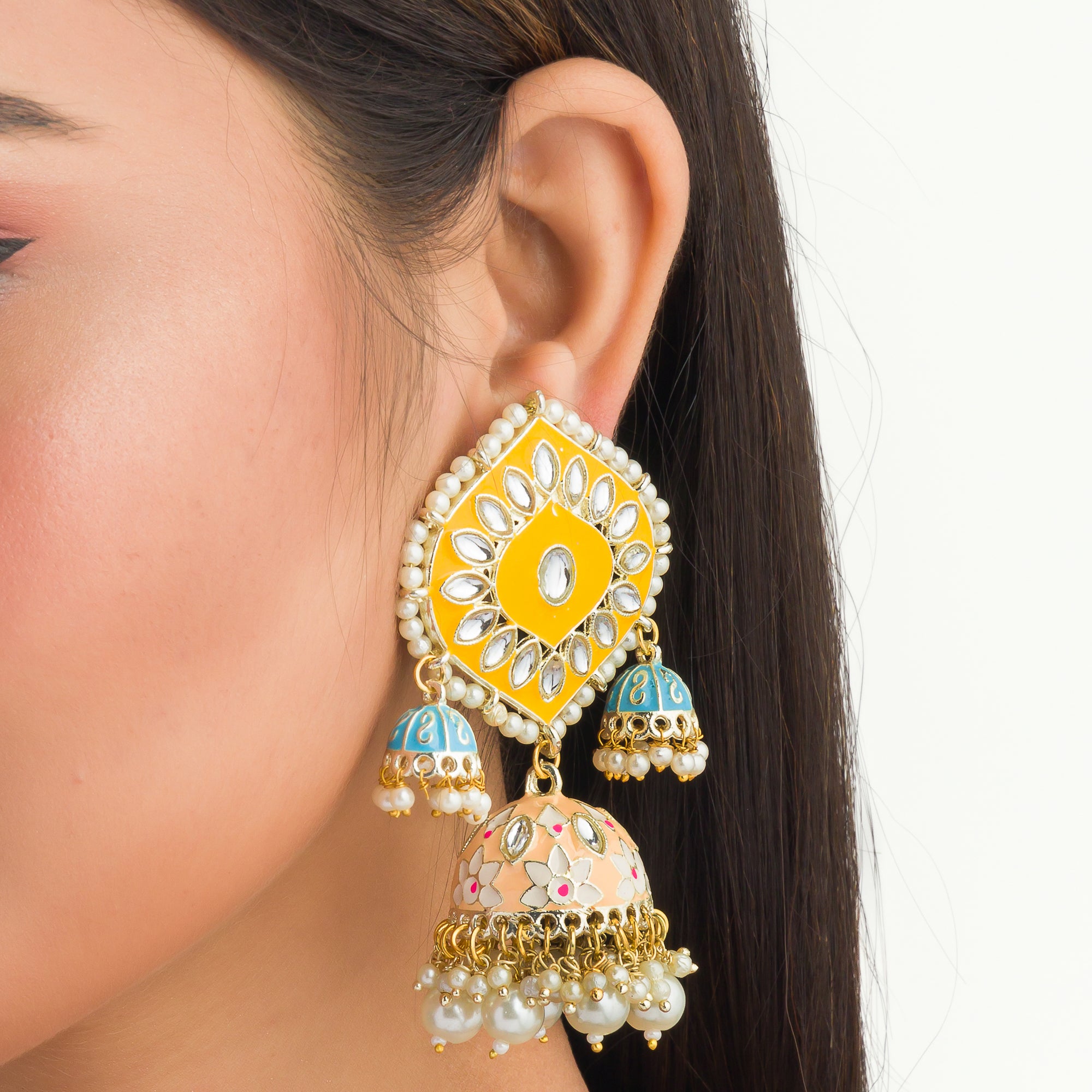 "Yellow and blue gold jhumka earrings blend bold colors with classic elegance for a striking look."
