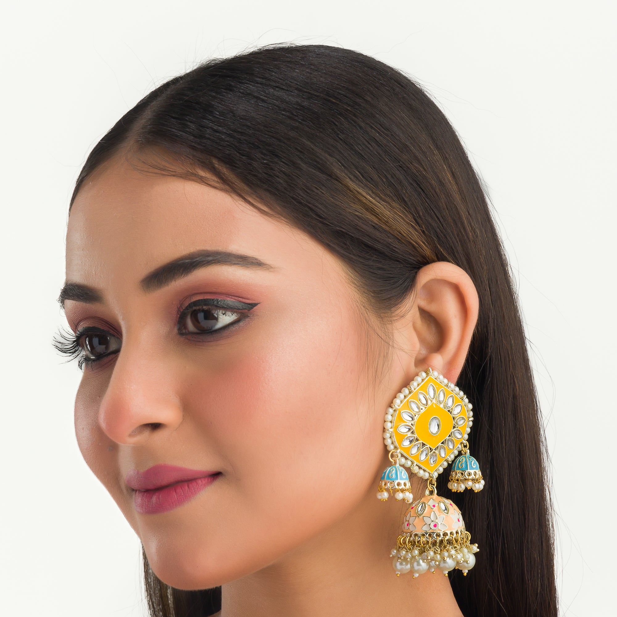 "Yellow and blue gold jhumka earrings blend bold colors with classic elegance for a striking look."
