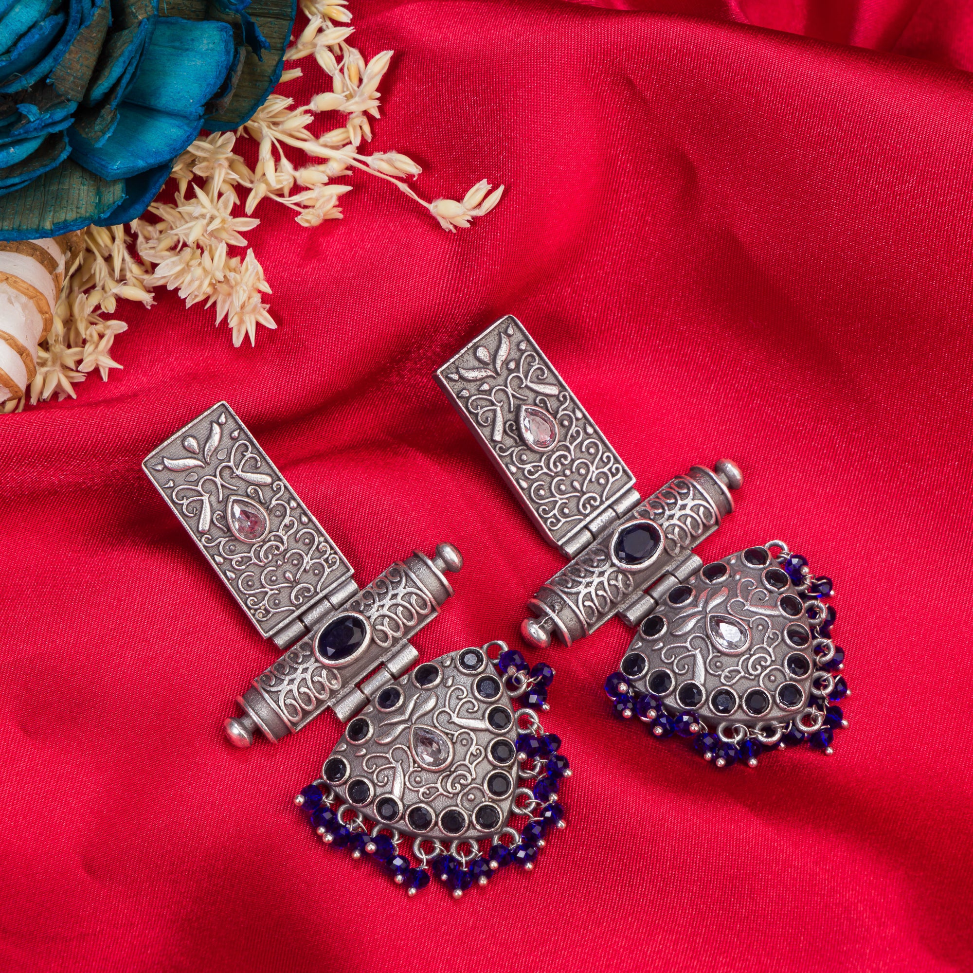 "Oxidized earrings with blue beads offer a unique vintage touch and a pop of color."
