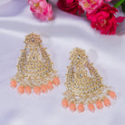 "Salmon color Kundan earrings make a bold, elegant statement for festive occasions."
