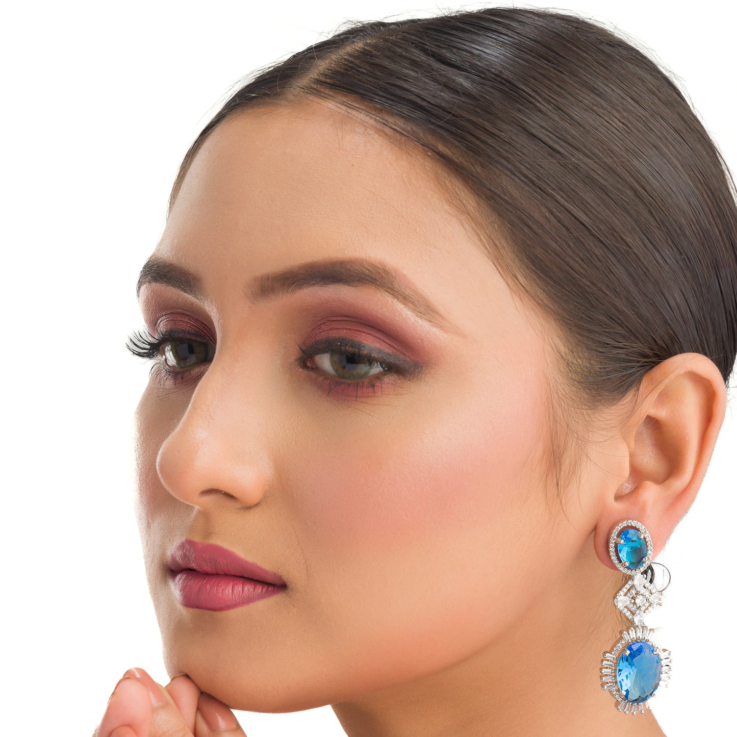 "BLUE ZIRCON DANGLER EARRINGS EXUDE A DEEP, CAPTIVATING SPARKLE."