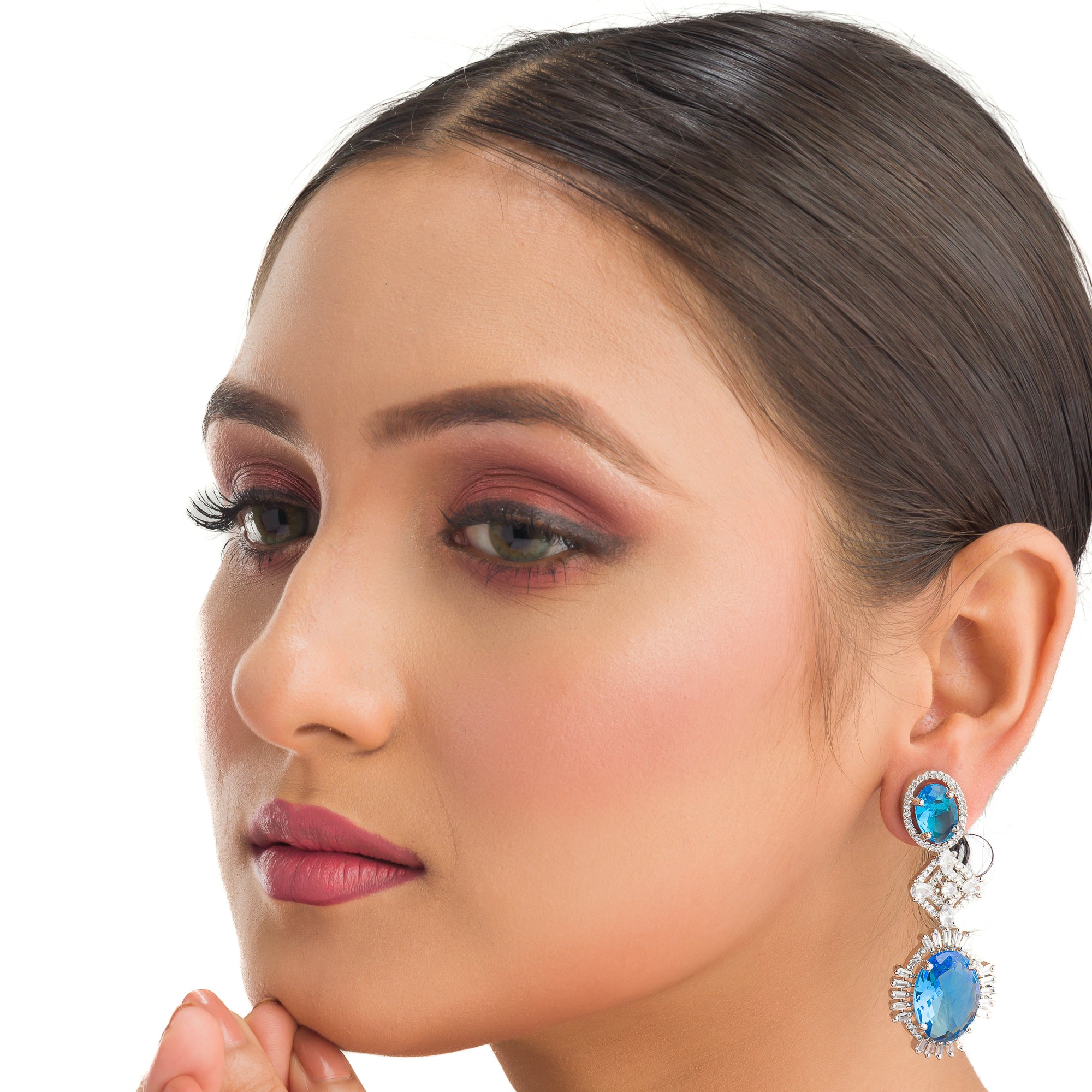 "Blue zircon dangler earrings exude a captivating sparkle, perfect for any party."
