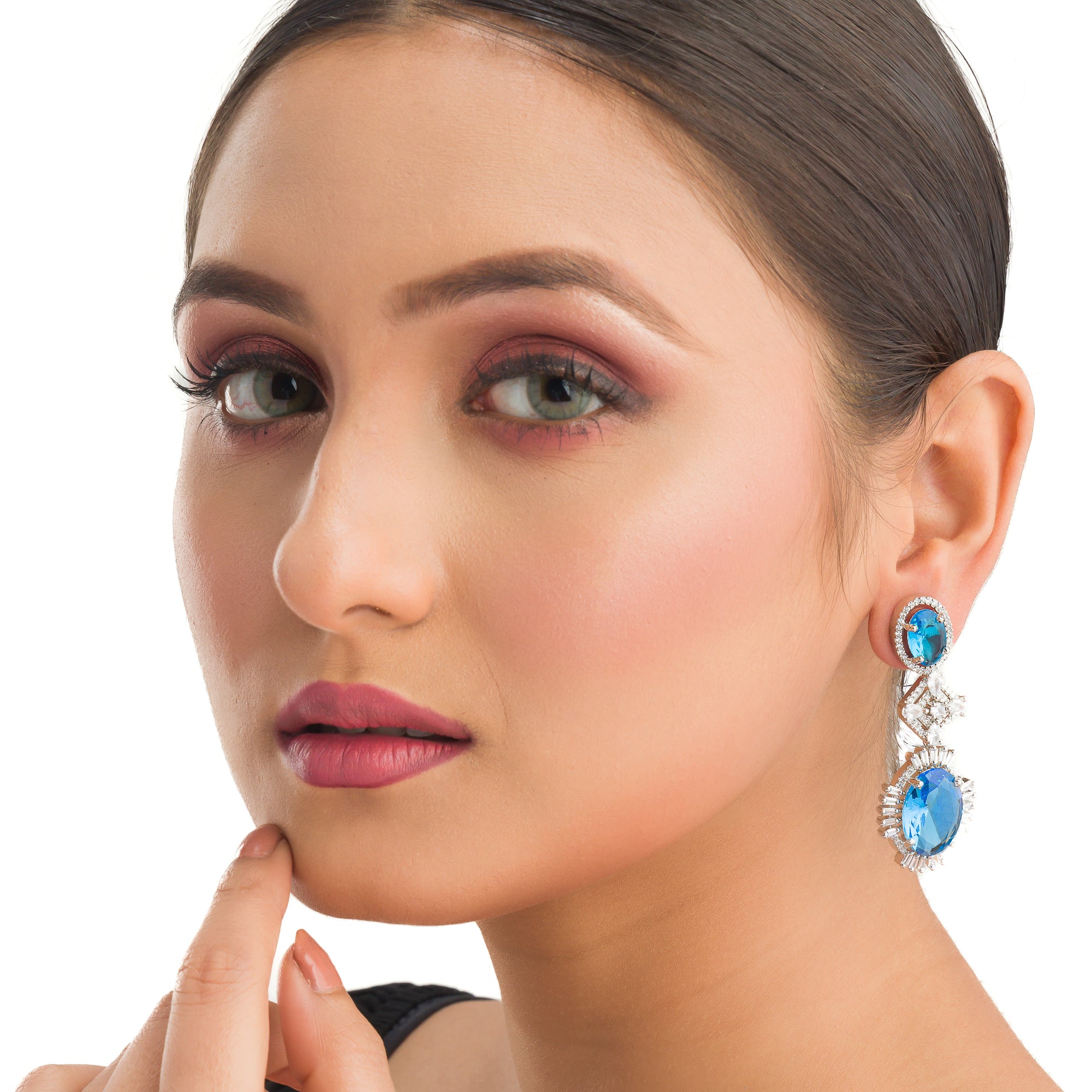 "Blue zircon dangler earrings exude a captivating sparkle, perfect for any party."
