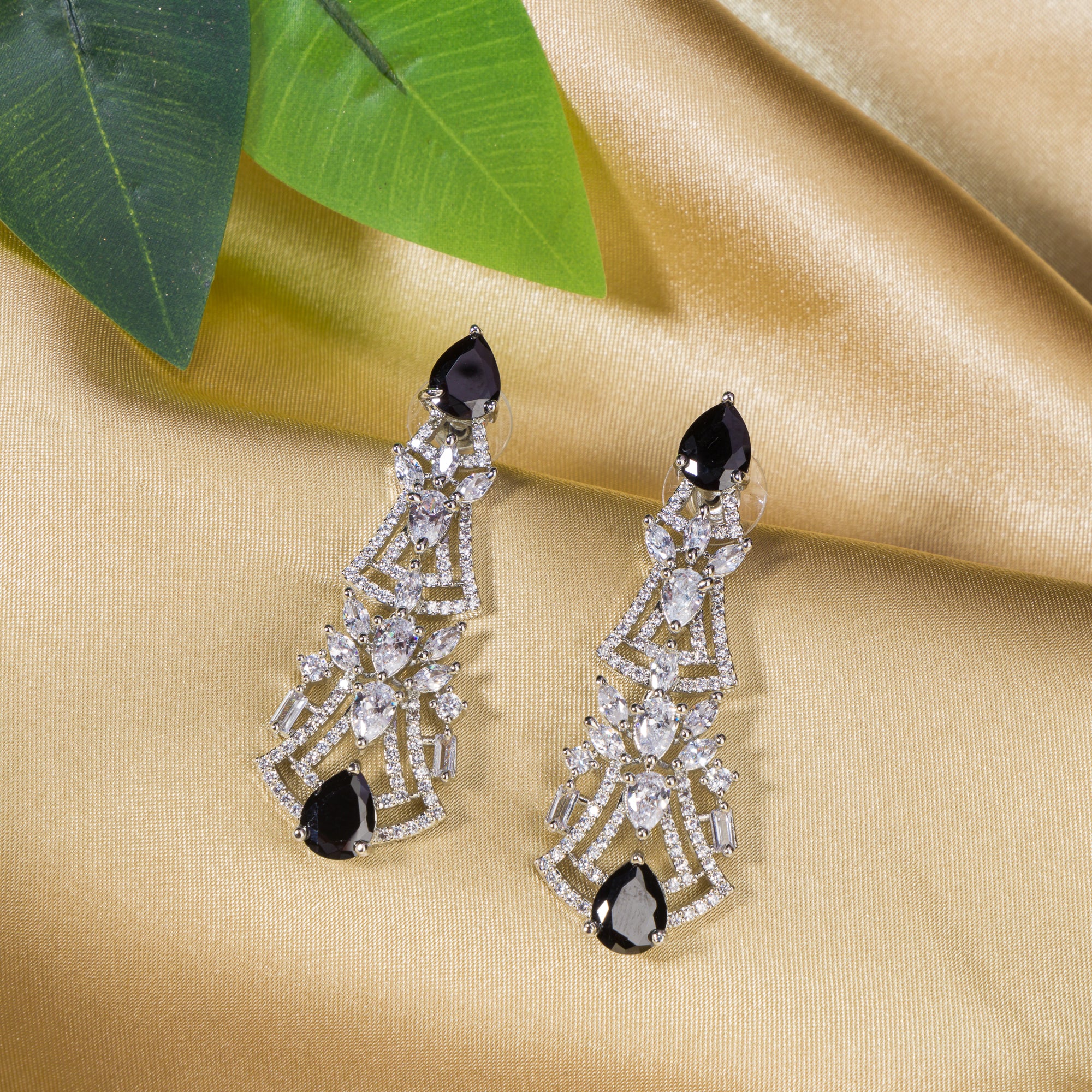 1. "Zircon earrings with black accents create a dramatic, elegant contrast."
