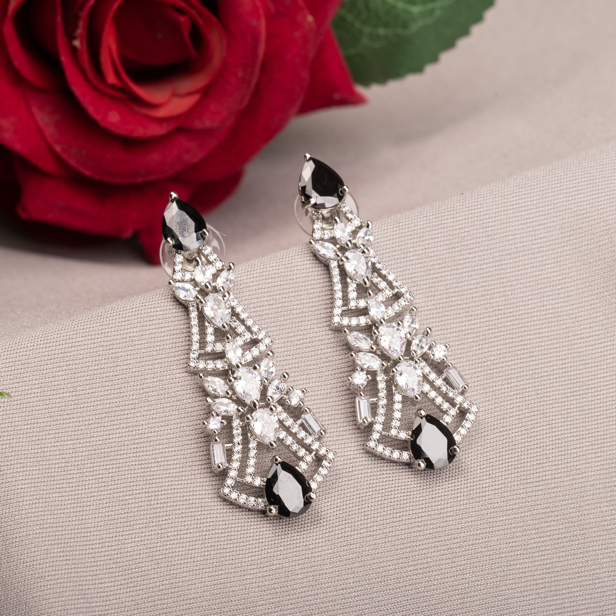 1. "Zircon earrings with black accents create a dramatic, elegant contrast."
