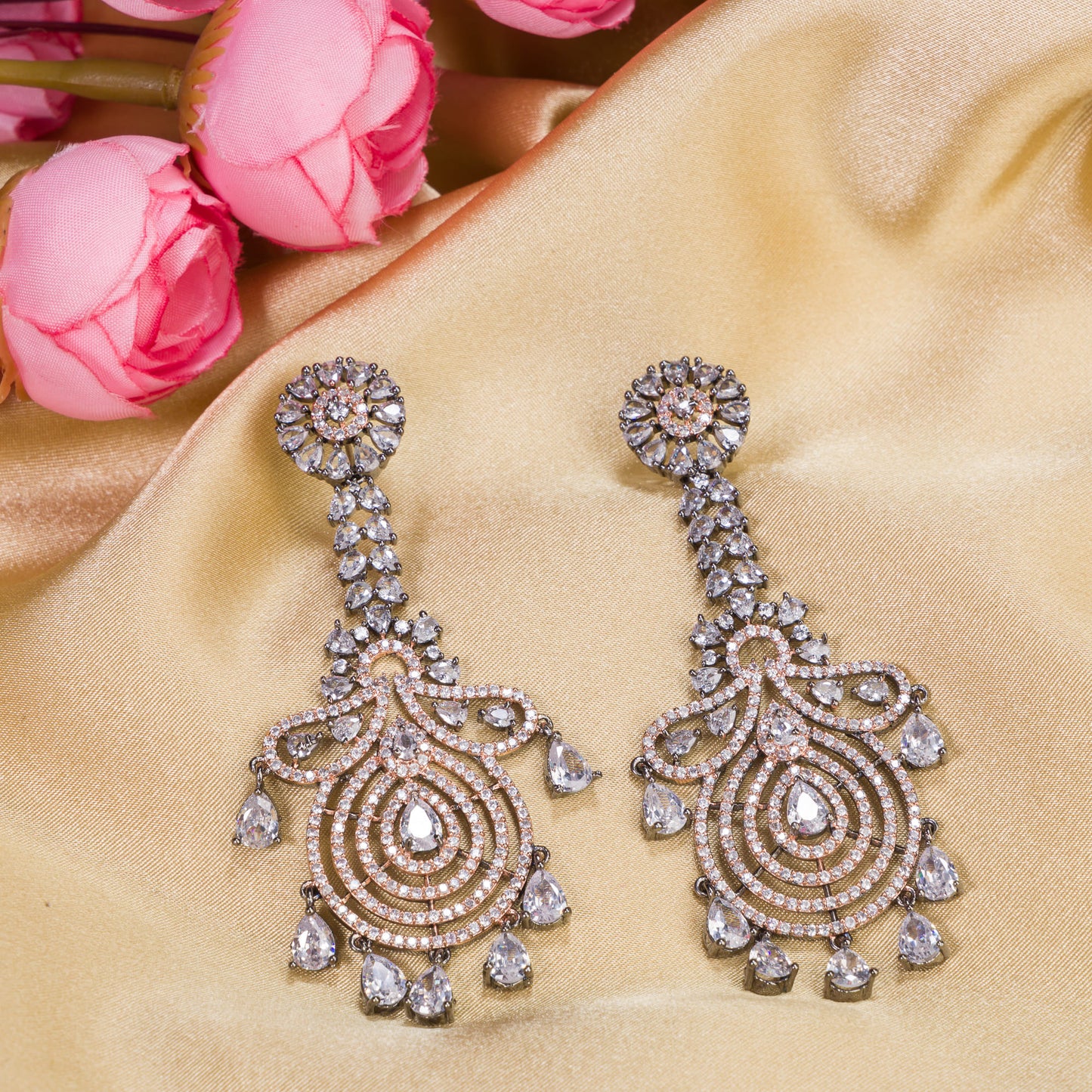 "LONG ZIRCON EARRINGS WITH BLACK ACCENTS AND ROSE GOLD POLISH DELIVER A SLEEK, SOPHISTICATED SPARKLE."