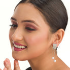 "Silver zircon earrings with hanging pearls offer elegant sparkle and sophistication."
