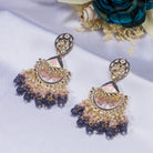 "Pink and white zircon jhumkas blend vibrant color with timeless elegance for a stunning look."
