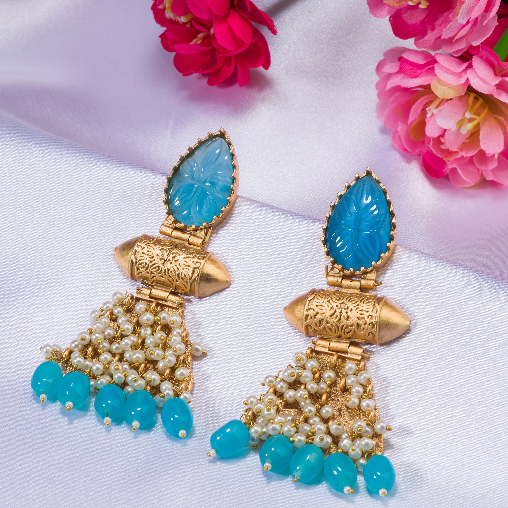 "Blue earrings with gold-tone polish combine vibrant color and a sophisticated finish."
