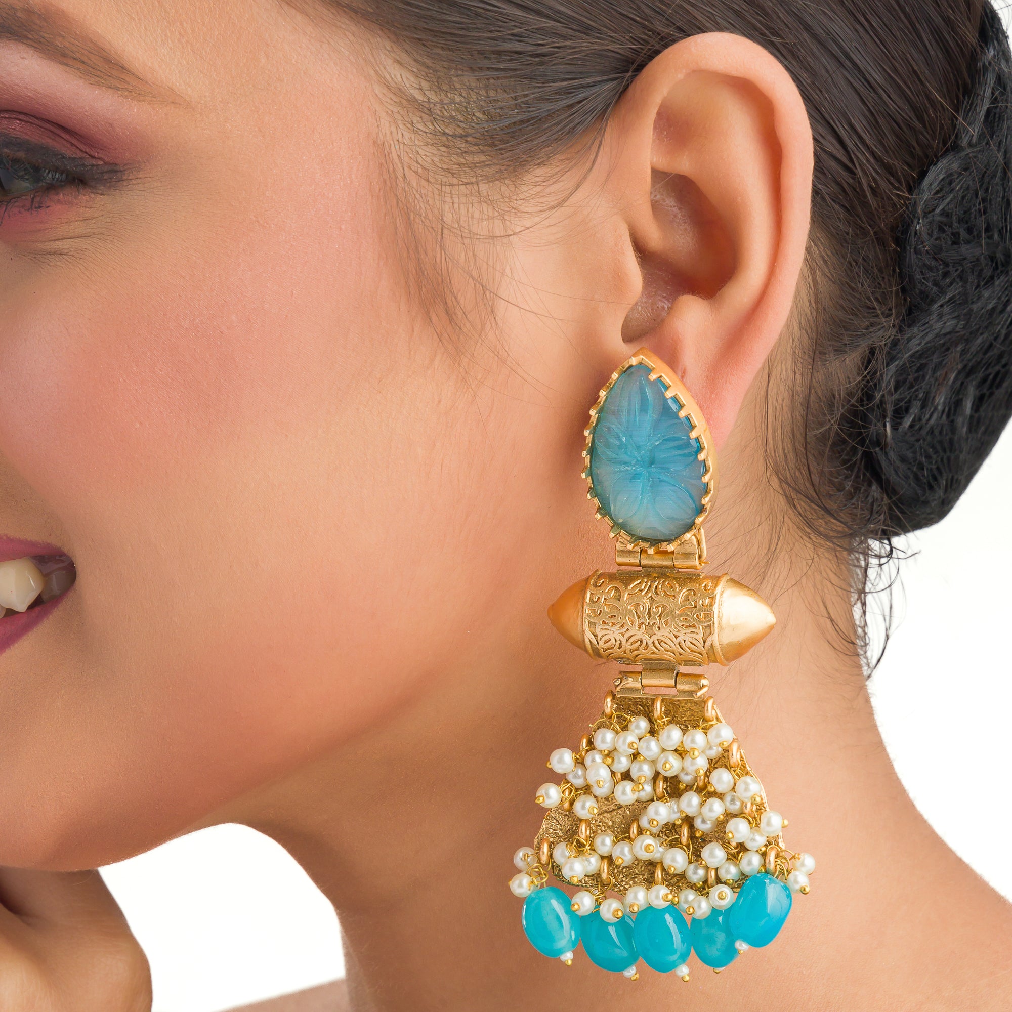 "Blue earrings with gold-tone polish combine vibrant color and a sophisticated finish."
