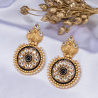 "Gold-tone earrings with black pearl add elegant warmth and striking contrast to any outfit."
