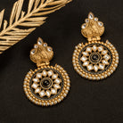 "Gold-tone earrings with black pearl add elegant warmth and striking contrast to any outfit."
