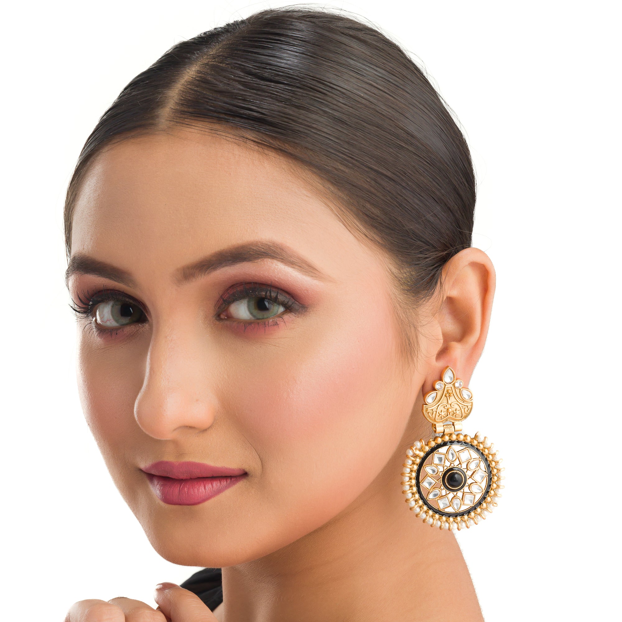 "Gold-tone earrings with black pearl add elegant warmth and striking contrast to any outfit."
