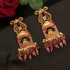 "Ganesh idol earrings with kundan and gold-tone polish add classic charm and grace."
