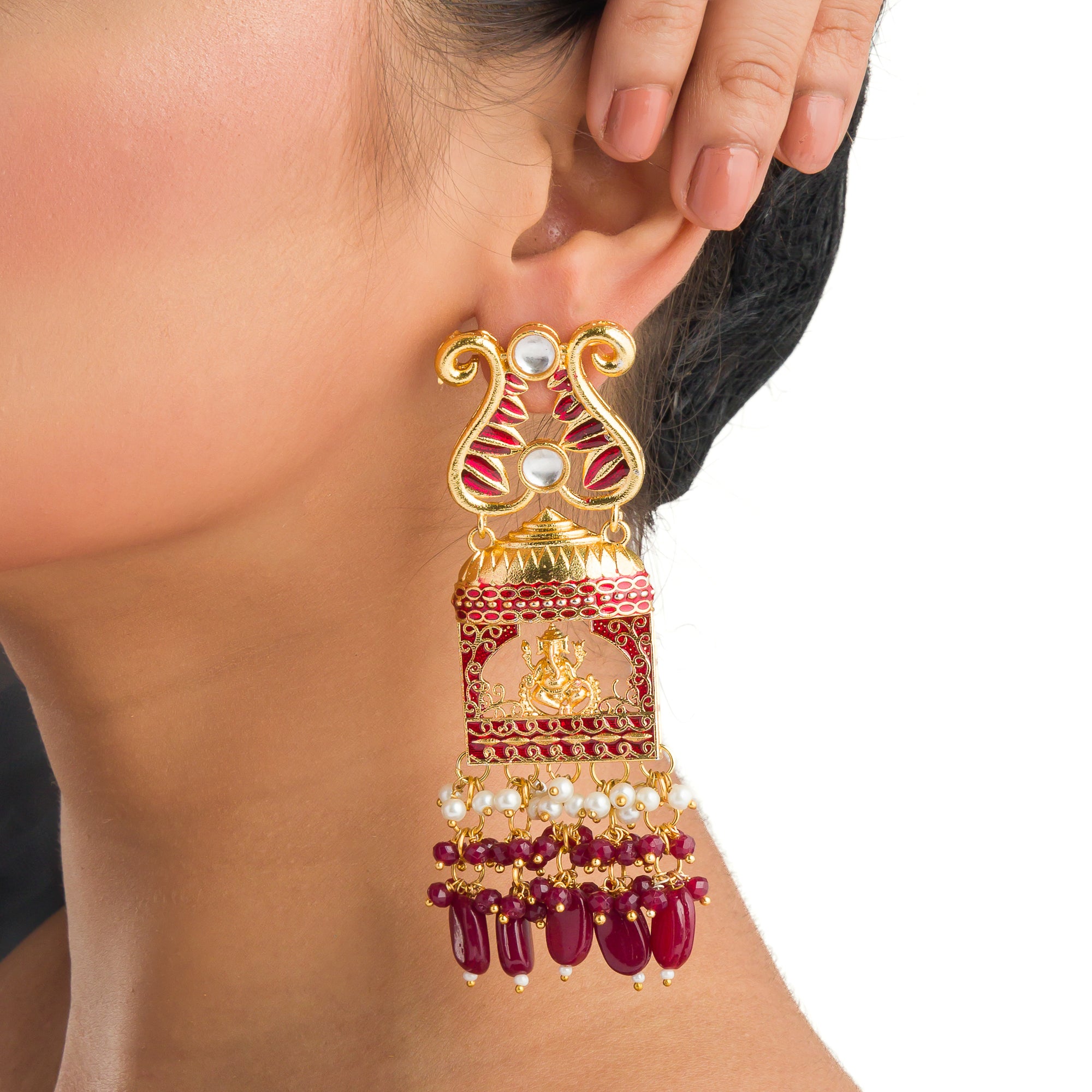 "Ganesh idol earrings with kundan and gold-tone polish add classic charm and grace."
