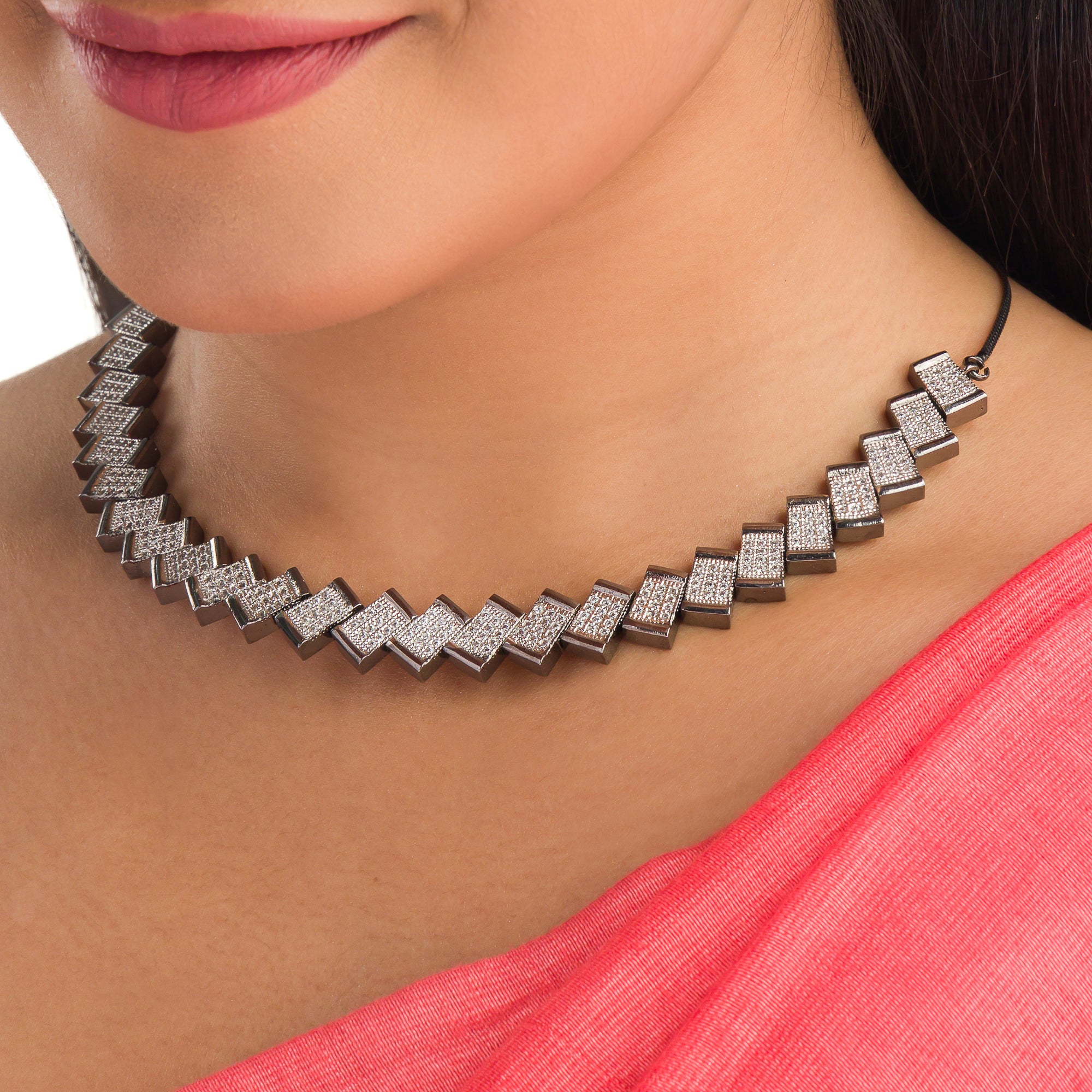 "Zigzag-shaped zircon necklace adds a modern twist to classic sparkle."
