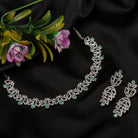 "Light green zircon necklace with leaf pattern adds subtle charm."
