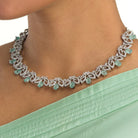 "Light green zircon necklace with leaf pattern adds subtle charm."
