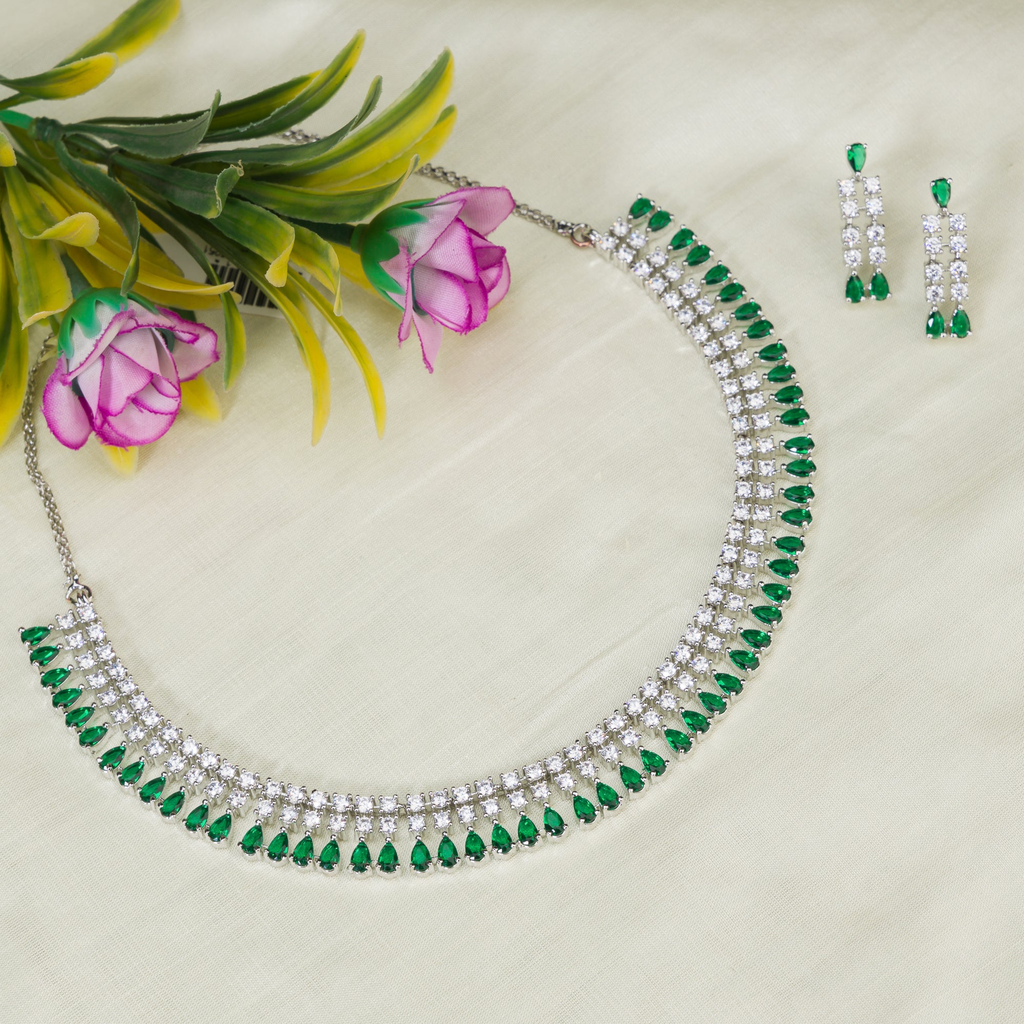 "Zircon necklace with white and green stones adds a vibrant, elegant touch."
