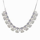 "Navy blue zircon necklace set with maang tikka exudes elegant coordination and style."
