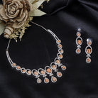 "Salmon zircon necklace with white zircons adds vibrant sparkle for a lively, chic look."
