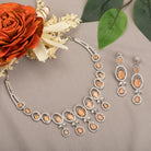 "Salmon zircon necklace with white zircons adds vibrant sparkle for a lively, chic look."
