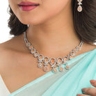 "Salmon zircon necklace with white zircons adds vibrant sparkle for a lively, chic look."
