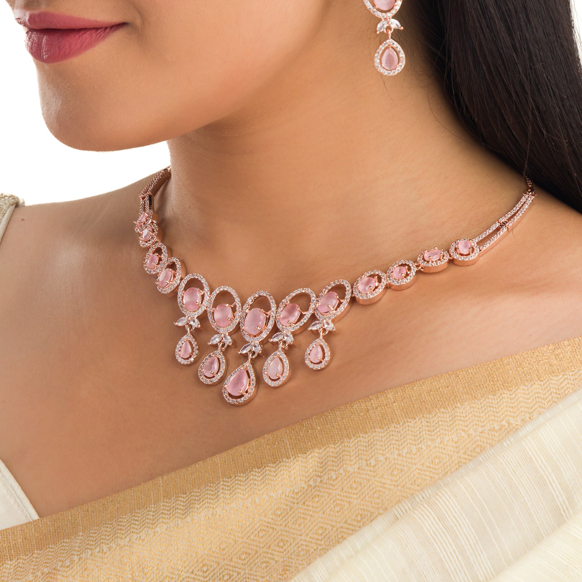 Pink zircon necklace with rose gold polish adds a chic and elegant finishing touch
