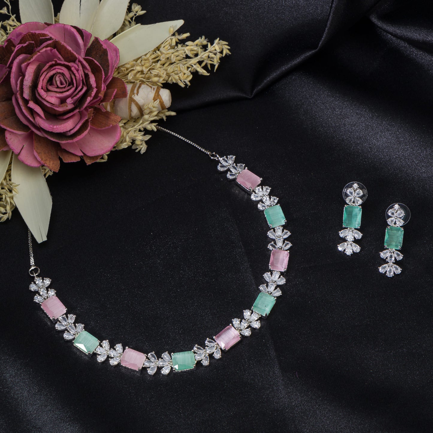 A TRENDY PINK AND GREEN ZIRCON NECKLACE IN A SQUARE DESIGN ADDS CHIC CHARM.