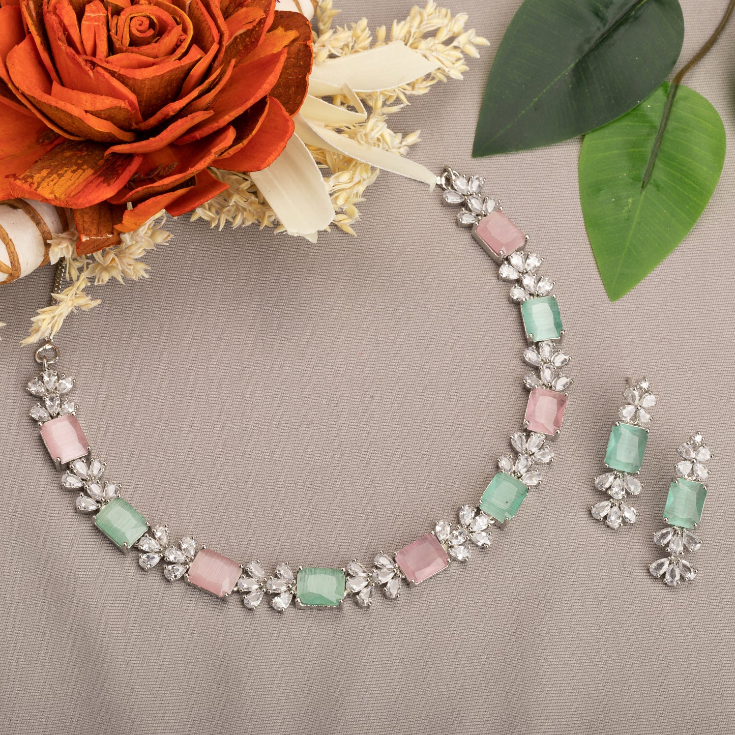 A TRENDY PINK AND GREEN ZIRCON NECKLACE IN A SQUARE DESIGN ADDS CHIC CHARM.