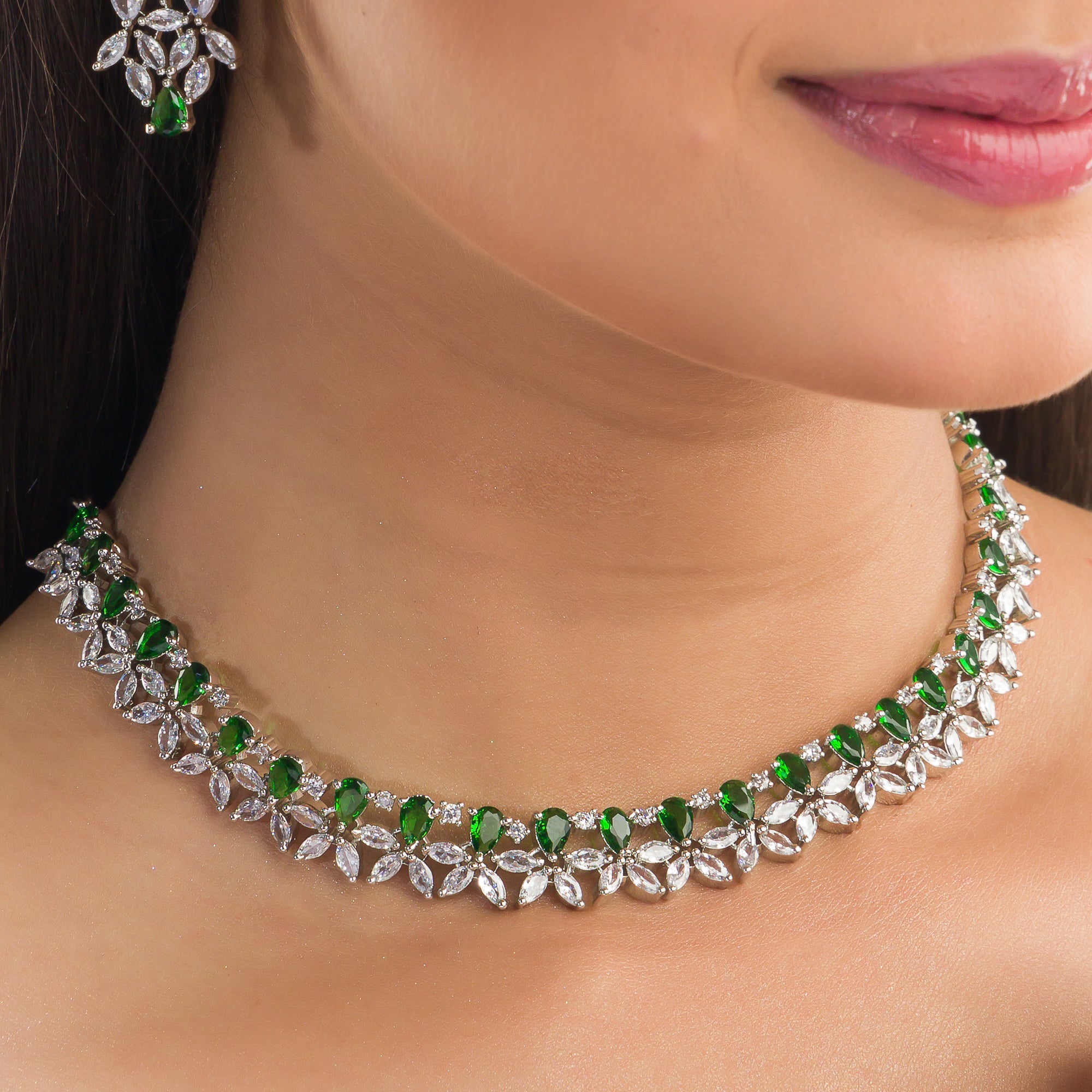 "Green and white zircon necklace in floral design adds vibrant, floral elegance."
