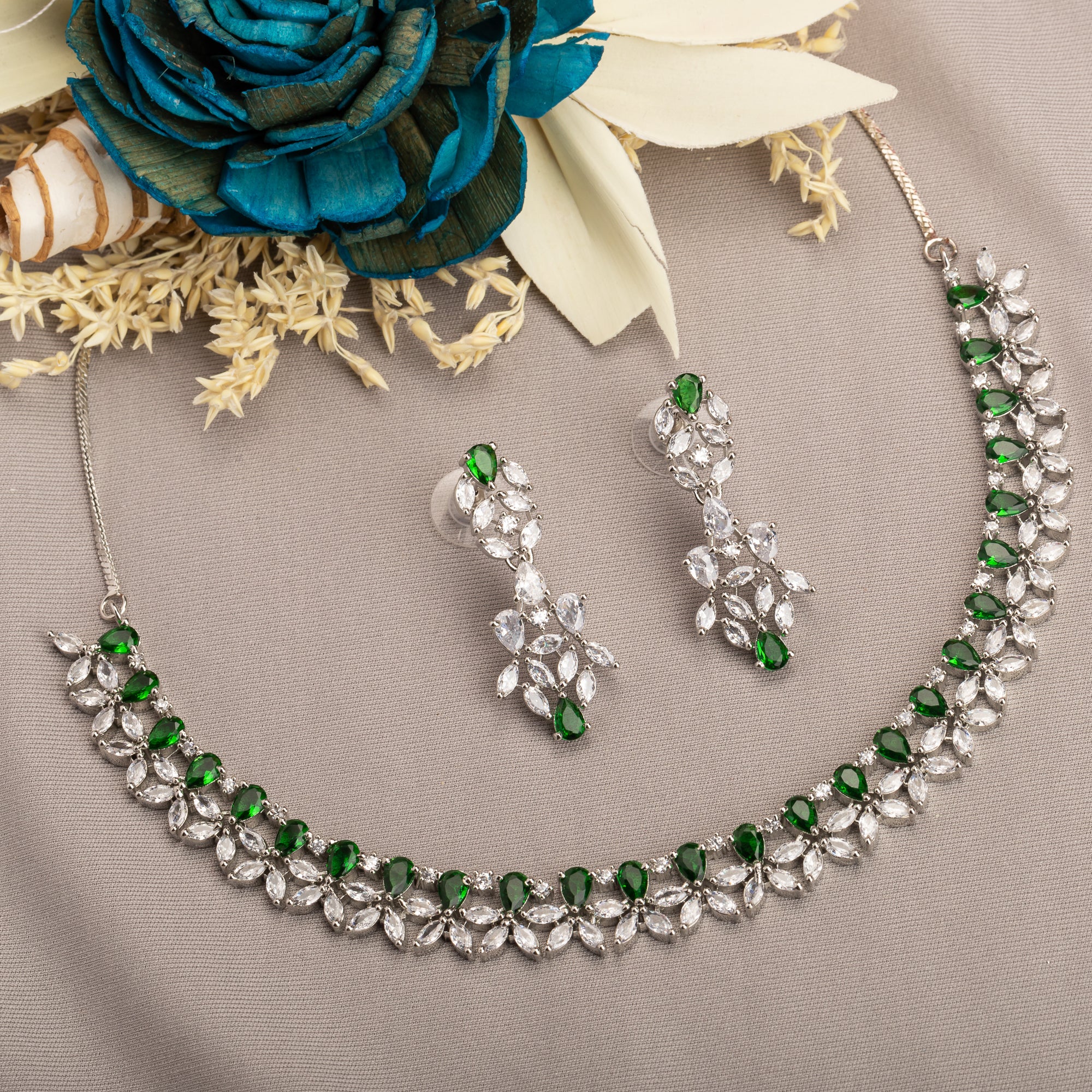 "Green and white zircon necklace in floral design adds vibrant, floral elegance."
