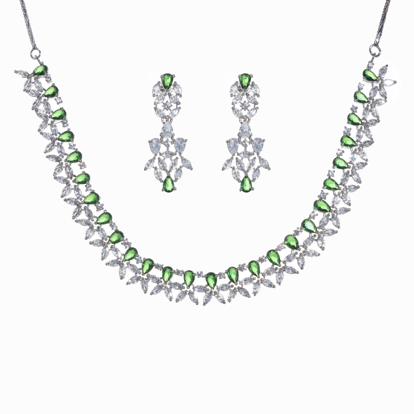 GREEN AND WHITE ZIRCONS IN A FLOWER DESIGN CREATE A VIBRANT, FLORAL ELEGANCE.