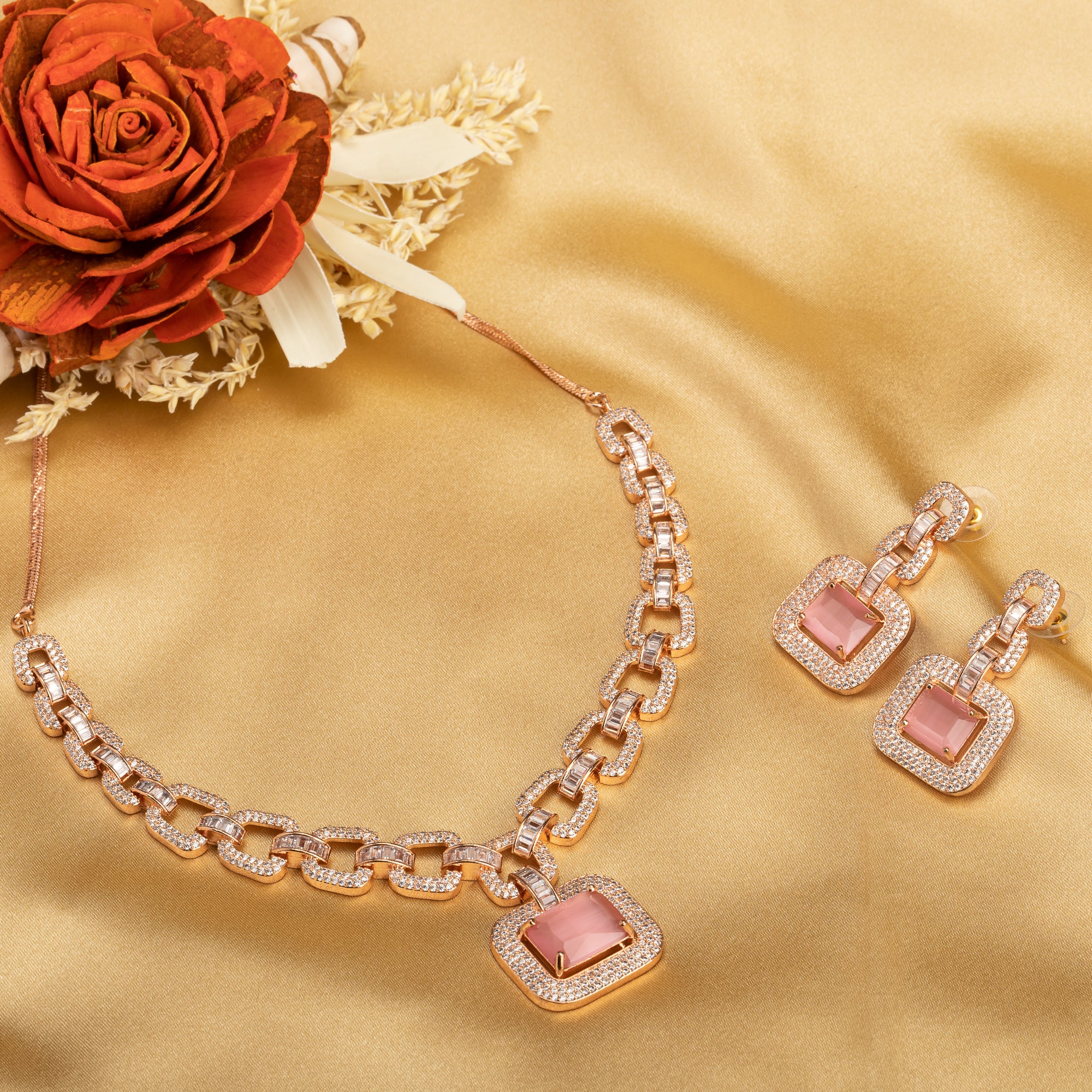 "Pink square and white zircon necklace with rose gold polish shines elegantly."
