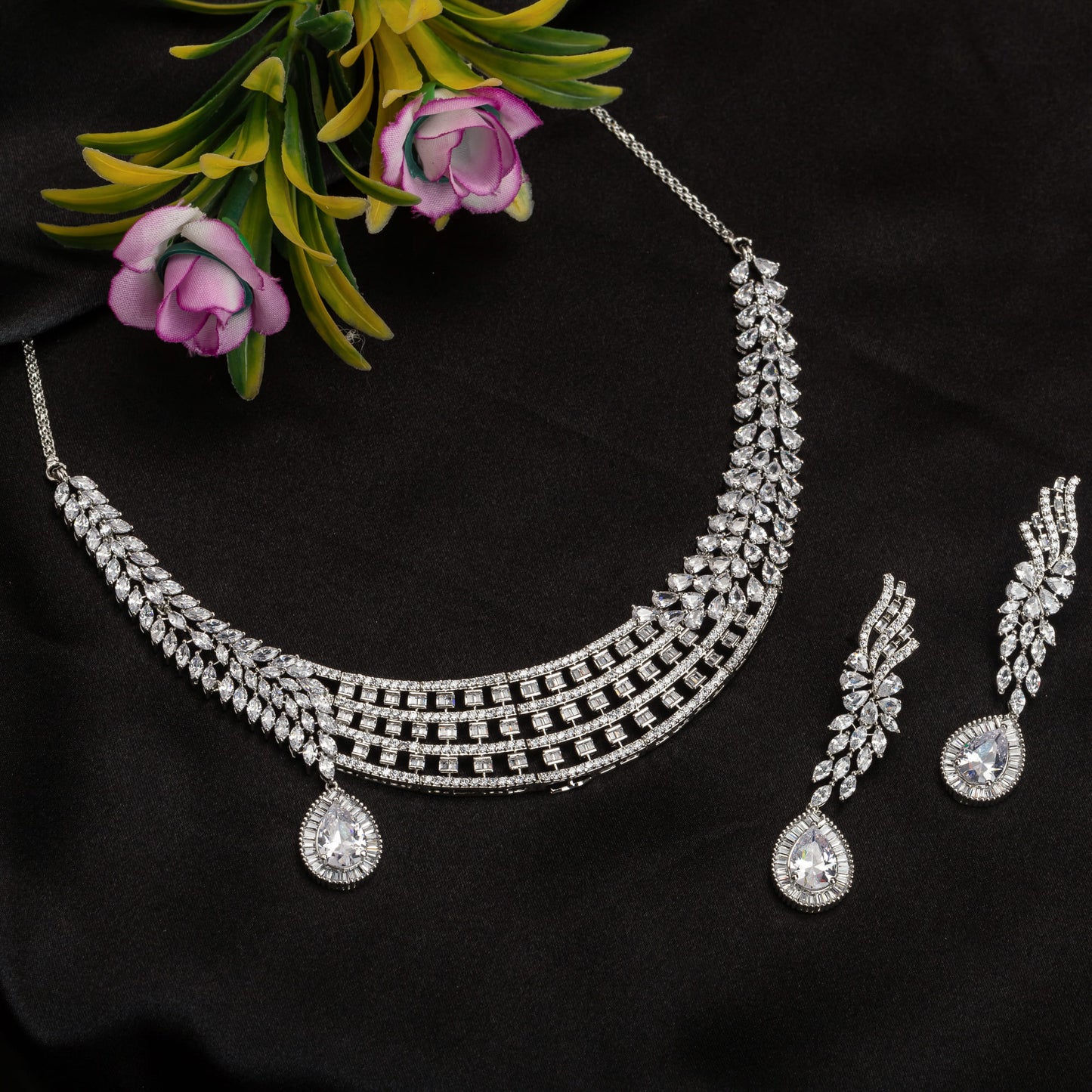 A ZIRCON NECKLACE WITH A LARGE ZIRCON STONE DROP ADDS DRAMATIC SPARKLE.