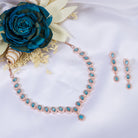 "Aqua zircon necklace with rose gold polish radiates modern elegance."
