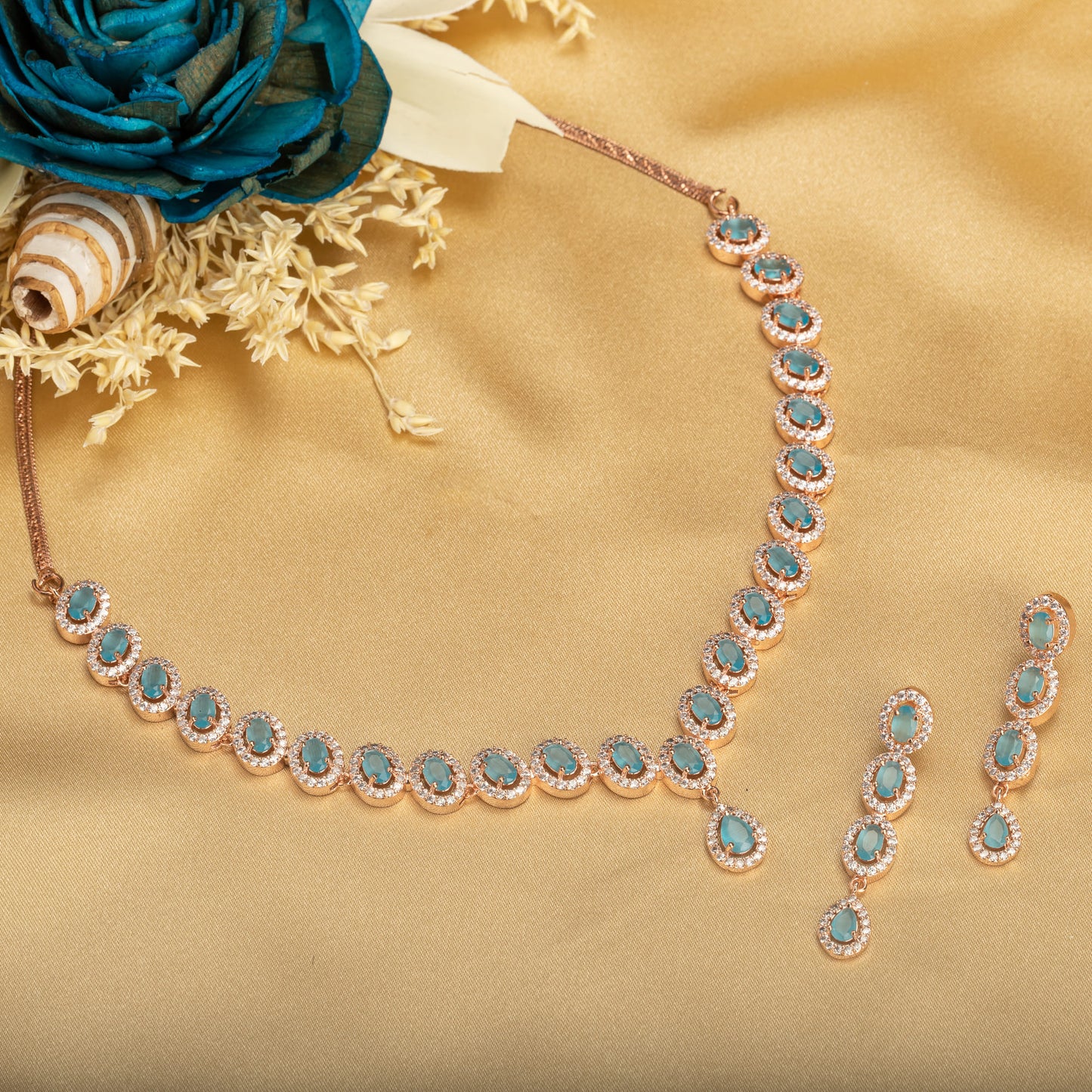 AN AQUA ZIRCON NECKLACE WITH ROSE GOLD POLISH RADIATES MODERN ELEGANCE.