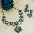 Tree-shaped necklace with green and white zircons brings a unique, elegant charm to any party look.
