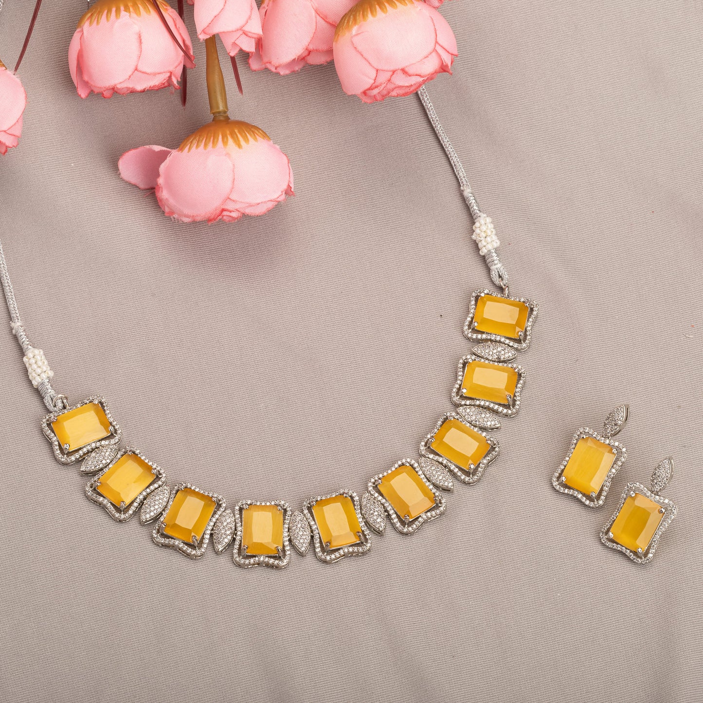 A YELLOW AND WHITE ZIRCON NECKLACE SPARKLES WITH VIBRANT CONTRAST.