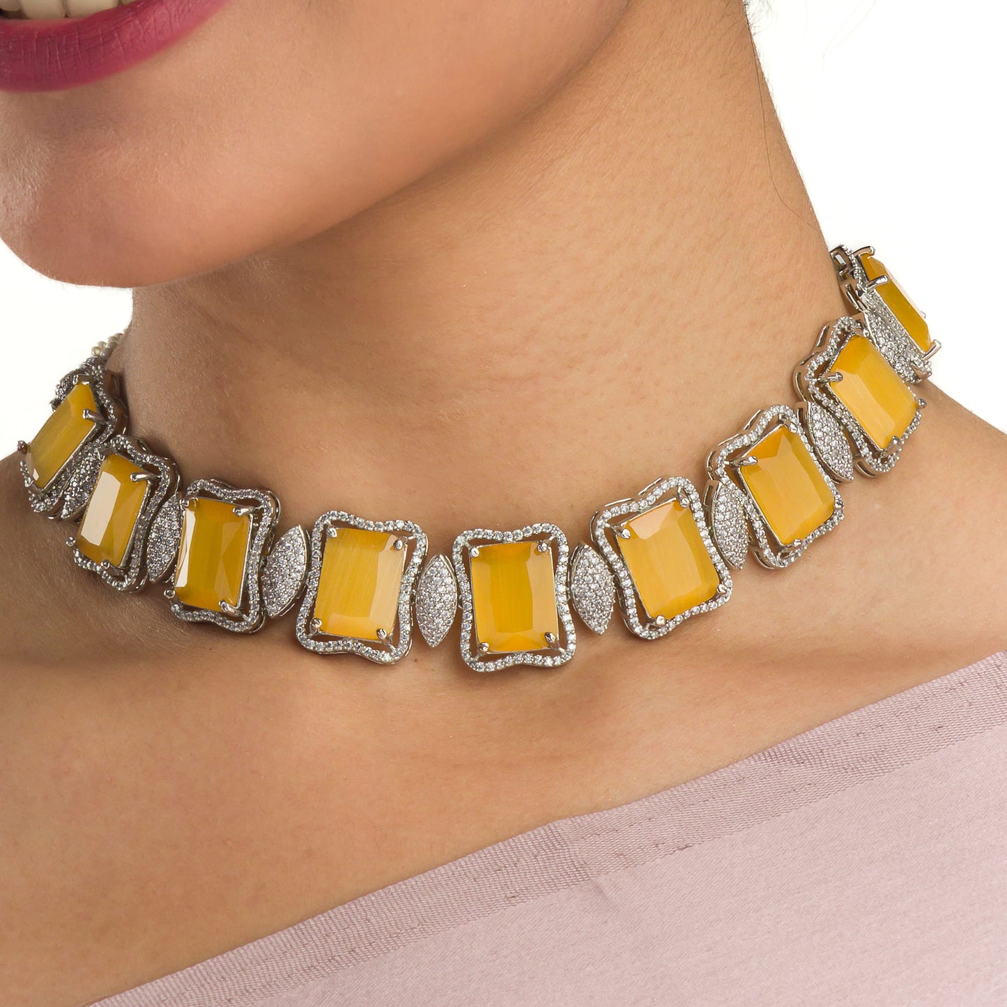 A YELLOW AND WHITE ZIRCON NECKLACE SPARKLES WITH VIBRANT CONTRAST.