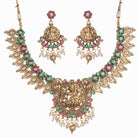 Intricate temple jewelry in red, gold, and green brings classic elegance to festival occasions.
