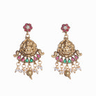 Intricate temple jewelry in red, gold, and green brings classic elegance to festival occasions.
