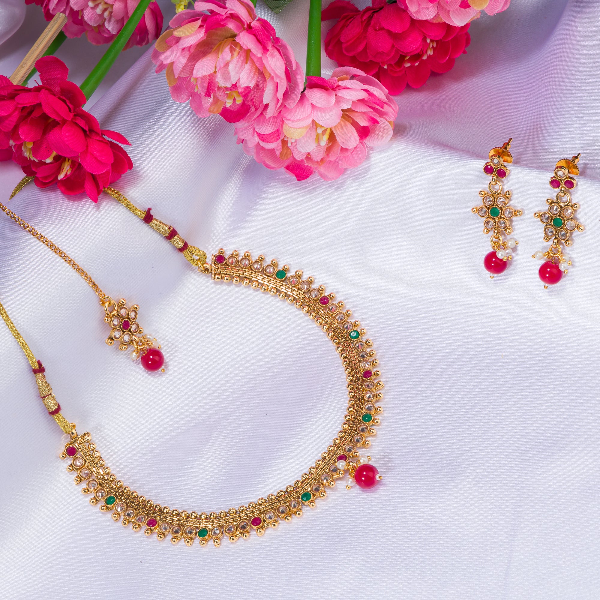 Gold-tone necklace with matching Maang Tikka offers a traditional and elegant festival ensemble.
