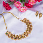 Vibrant gold-tone necklace with red, green stones, and white pearls for a stunning party look.
