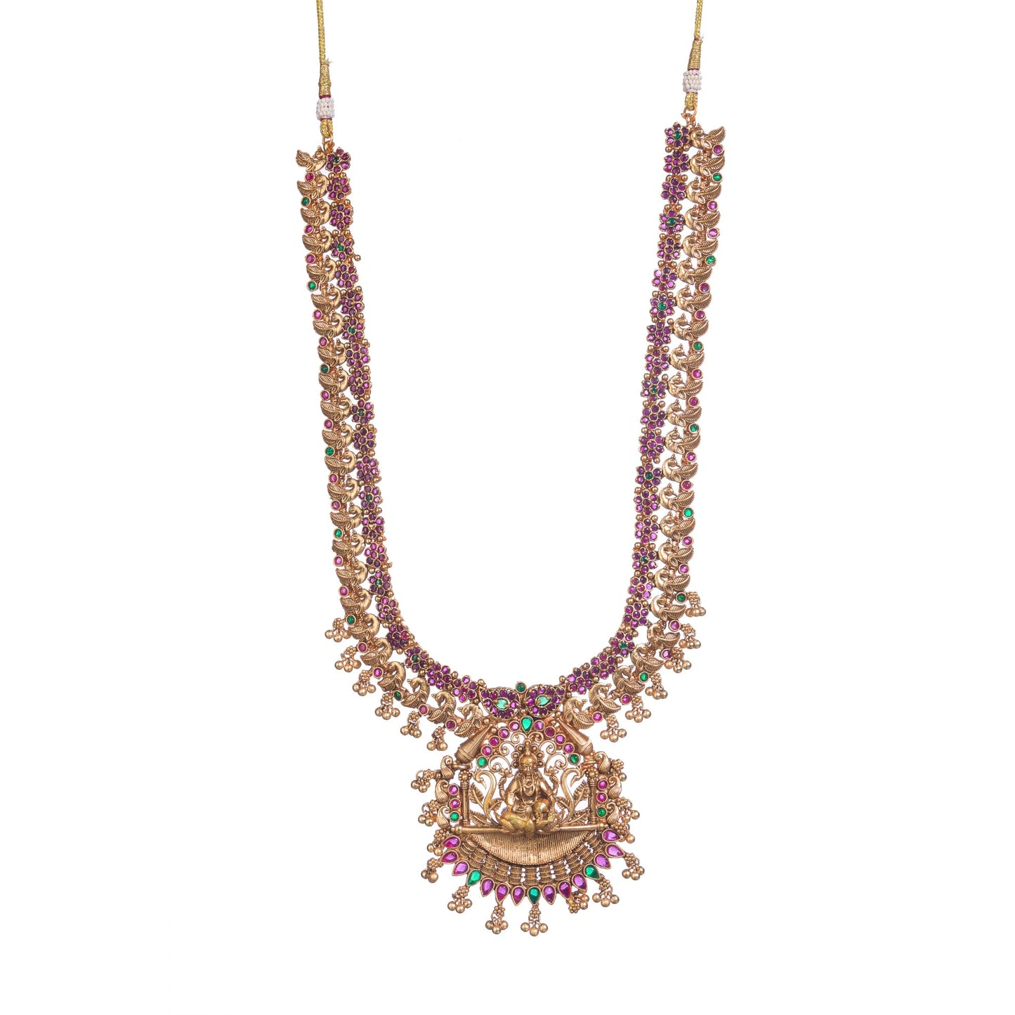 A TEMPLE JEWELLERY WITH RED AND GREEN STONES SHOWCASES TRADITIONAL OPULENCE.