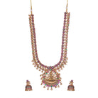 Traditional temple jewelry with red and green stones radiates timeless opulence and charm.
