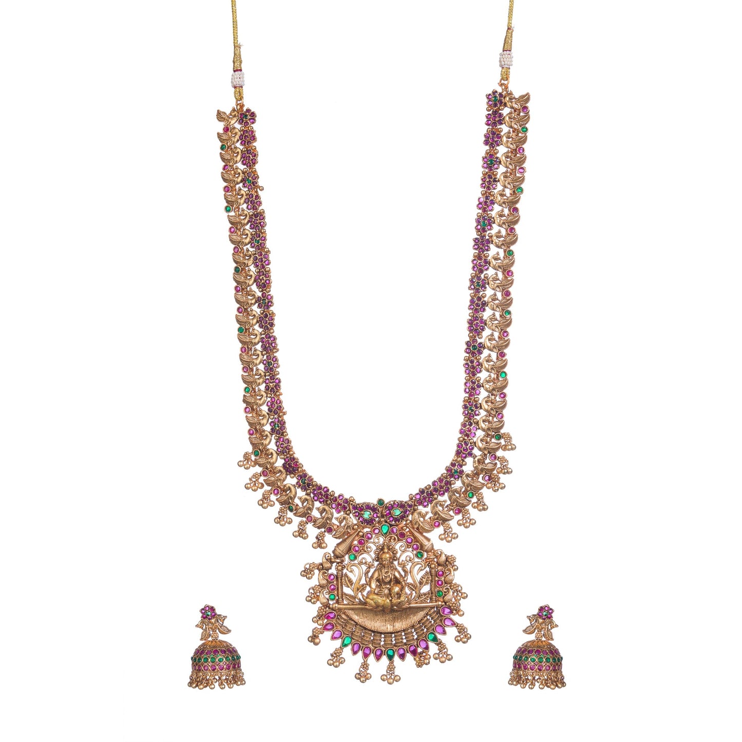 A TEMPLE JEWELLERY WITH RED AND GREEN STONES SHOWCASES TRADITIONAL OPULENCE.