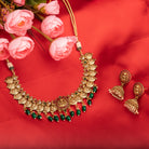 Temple necklace with green Kundan stones radiates vibrant, traditional festival elegance.
