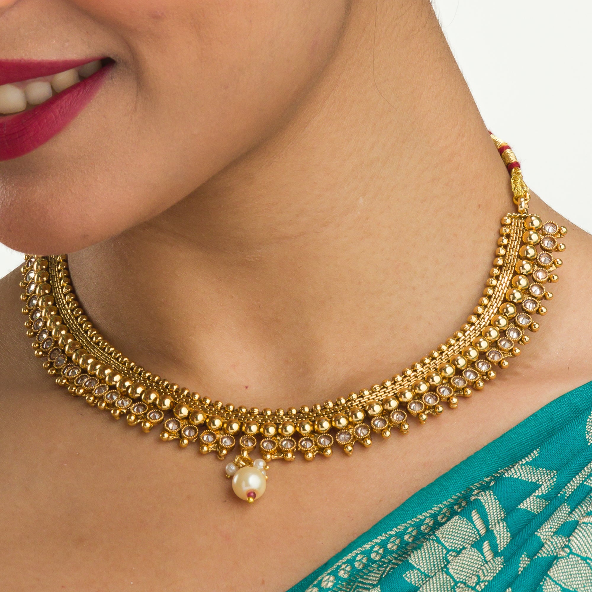 Sophisticated gold-tone choker exudes timeless charm for festive occasions.
